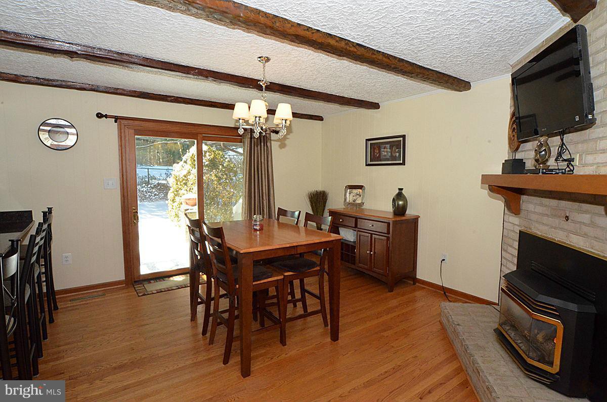 7900 Bennett Branch Road Mount Airy, MD 21771 - Photo 5 of 30 a view of a dining room with furniture a chandelier and wooden floor