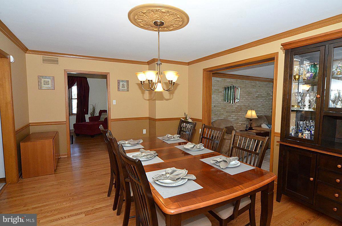 7900 Bennett Branch Road Mount Airy, MD 21771 - Photo 8 of 30 a view of a dining room with furniture wooden floor and chandelier