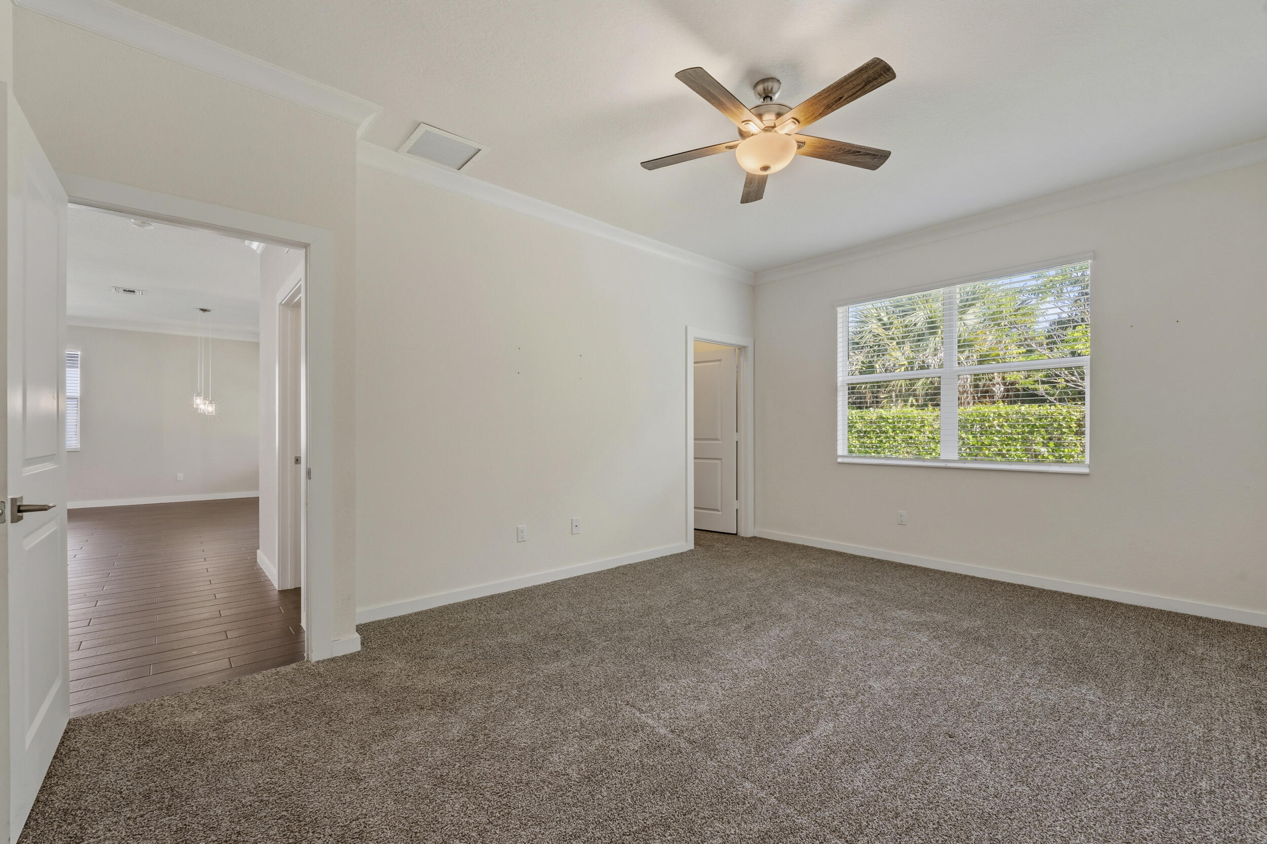 7461 Southwest Harbor Cove Drive Stuart, FL 34997 - Photo 17 of 30 an empty room with fan and windows