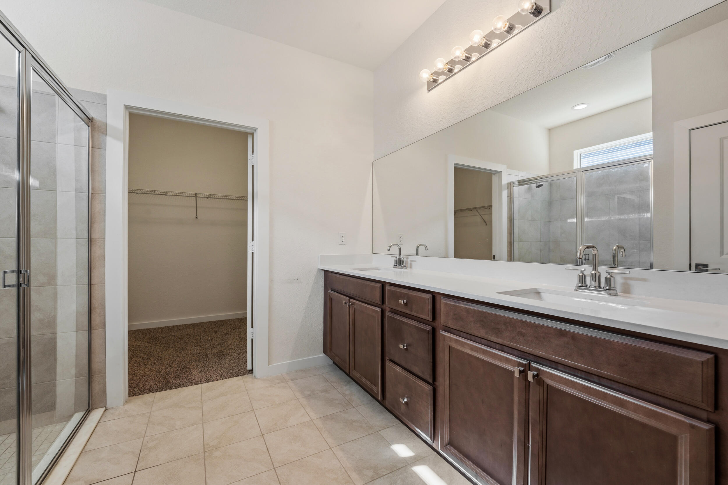 7461 Southwest Harbor Cove Drive Stuart, FL 34997 - Photo 20 of 30 a bathroom with a double vanity sink and mirror