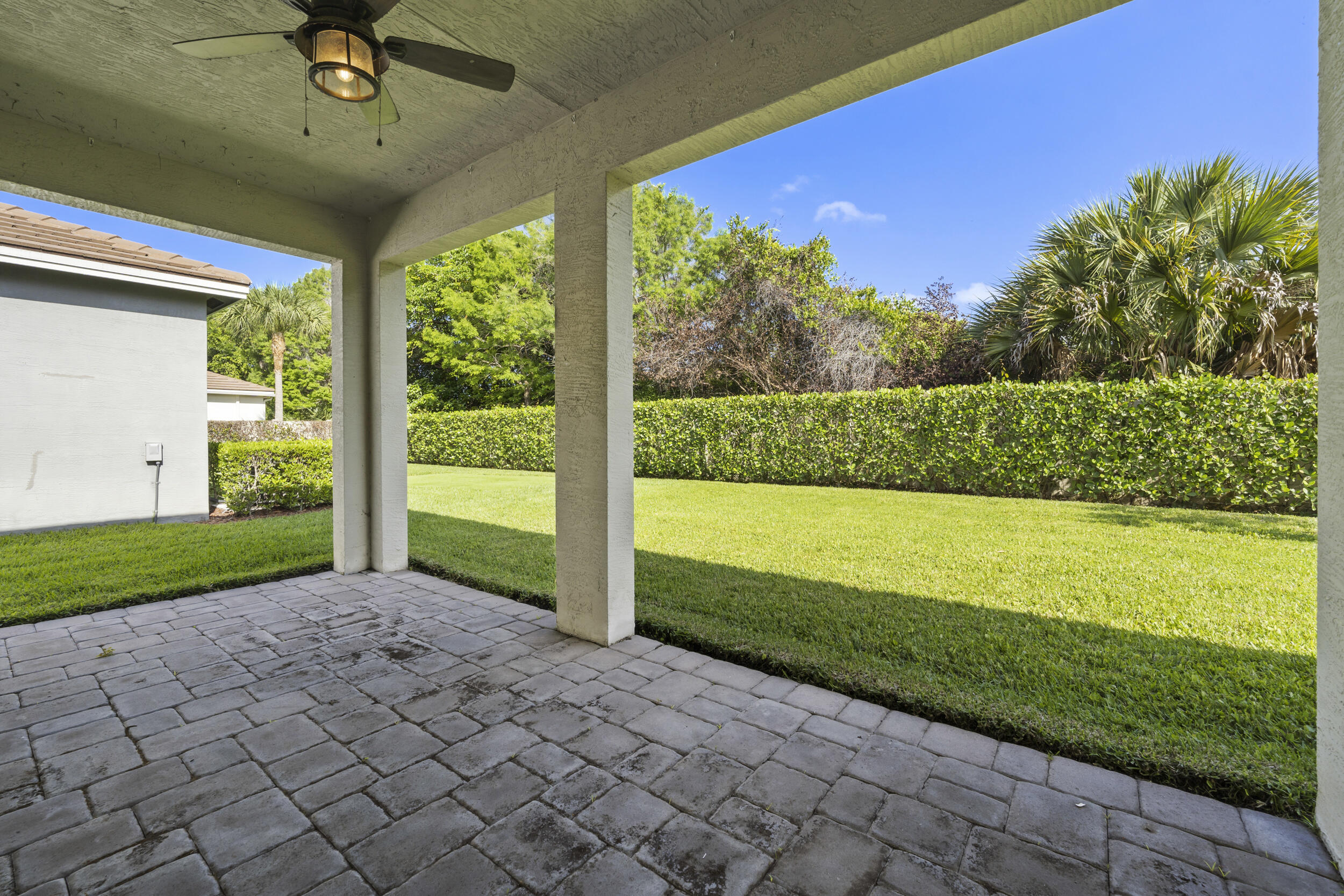7461 Southwest Harbor Cove Drive Stuart, FL 34997 - Photo 25 of 30 a view of a porch and garden