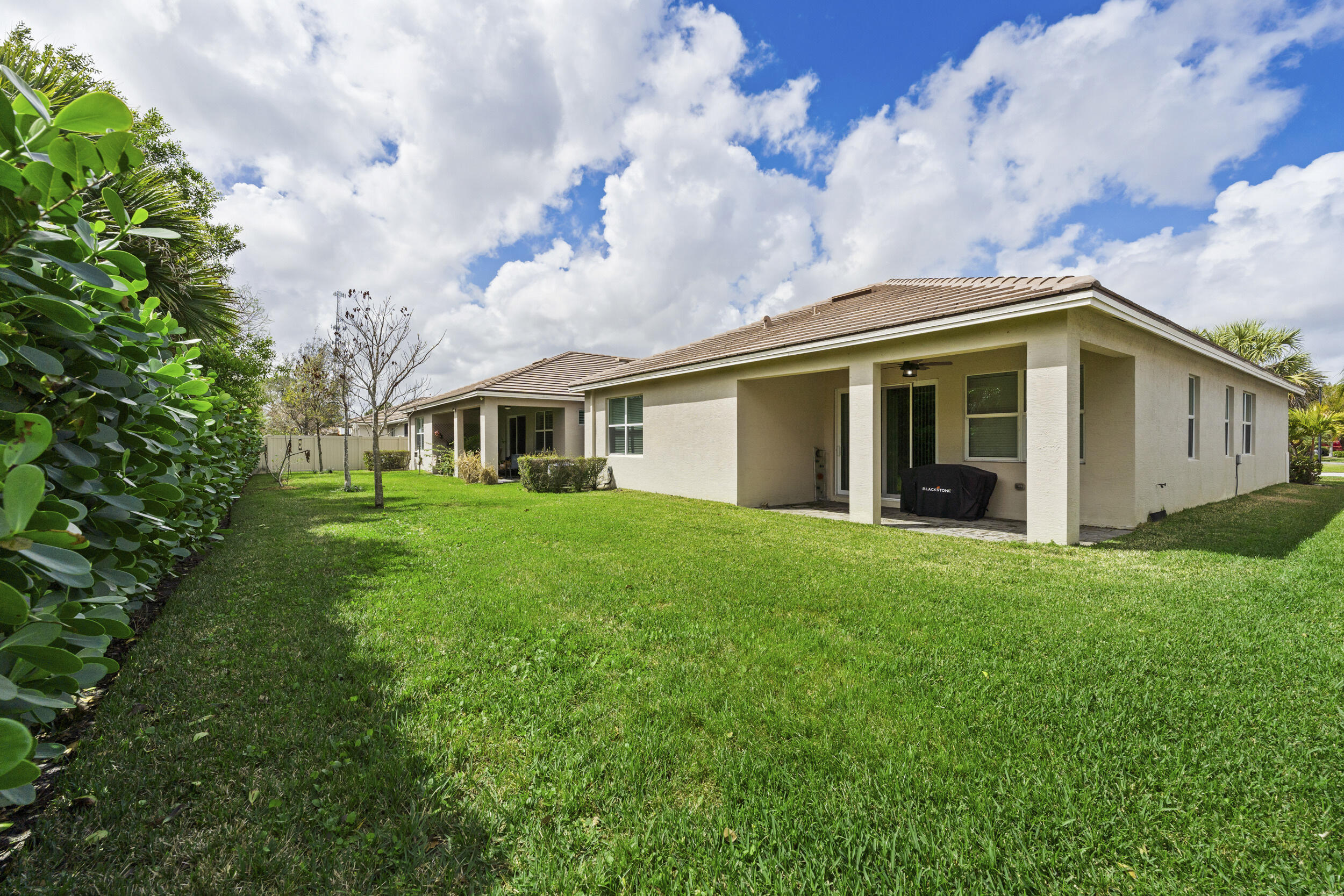 7461 Southwest Harbor Cove Drive Stuart, FL 34997 - Photo 26 of 30 a front view of house with yard and green space