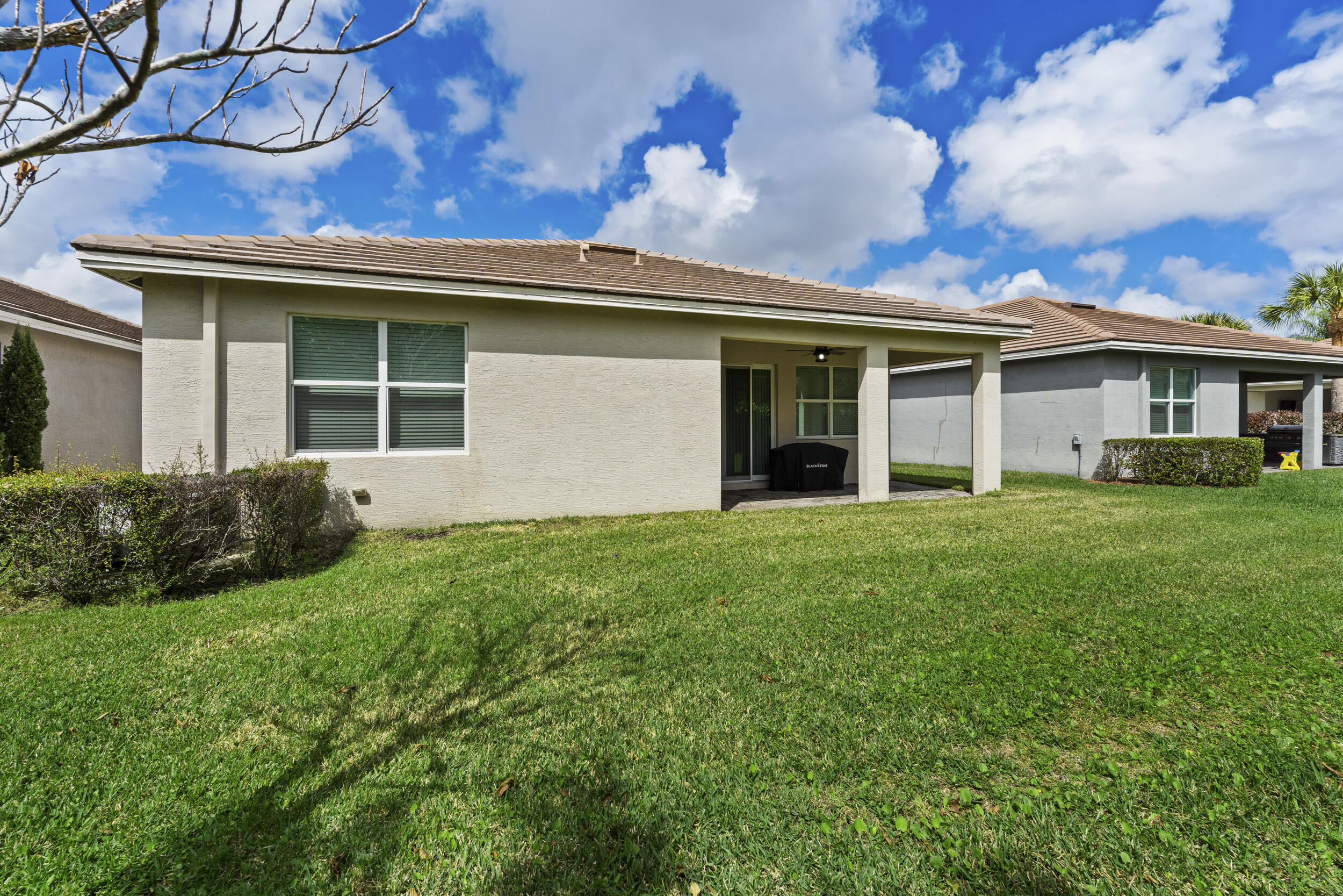 7461 Southwest Harbor Cove Drive Stuart, FL 34997 - Photo 27 of 30 a view of a house with a backyard