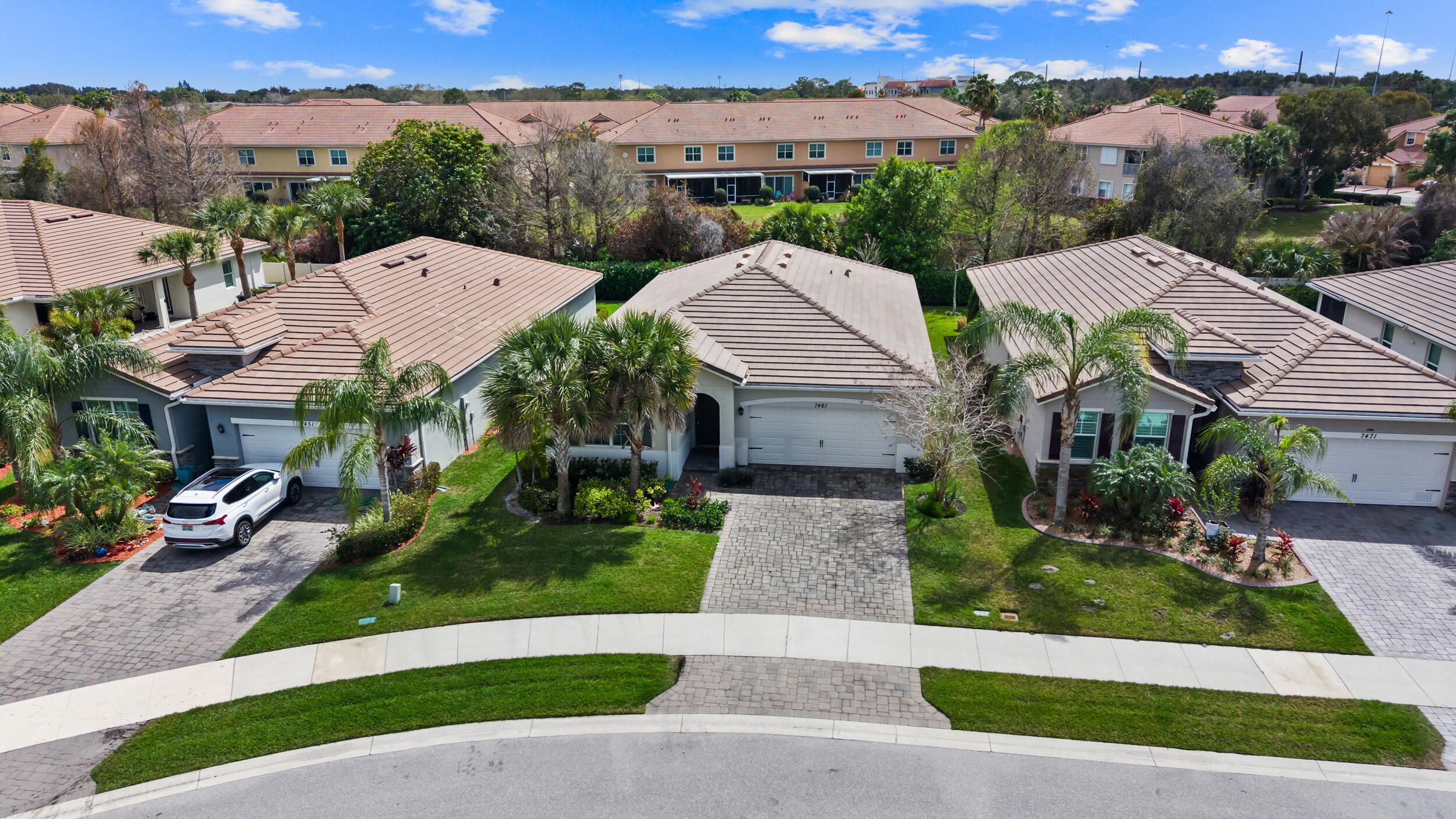 7461 Southwest Harbor Cove Drive Stuart, FL 34997 - Photo 3 of 30 an aerial view of multiple houses with a yard