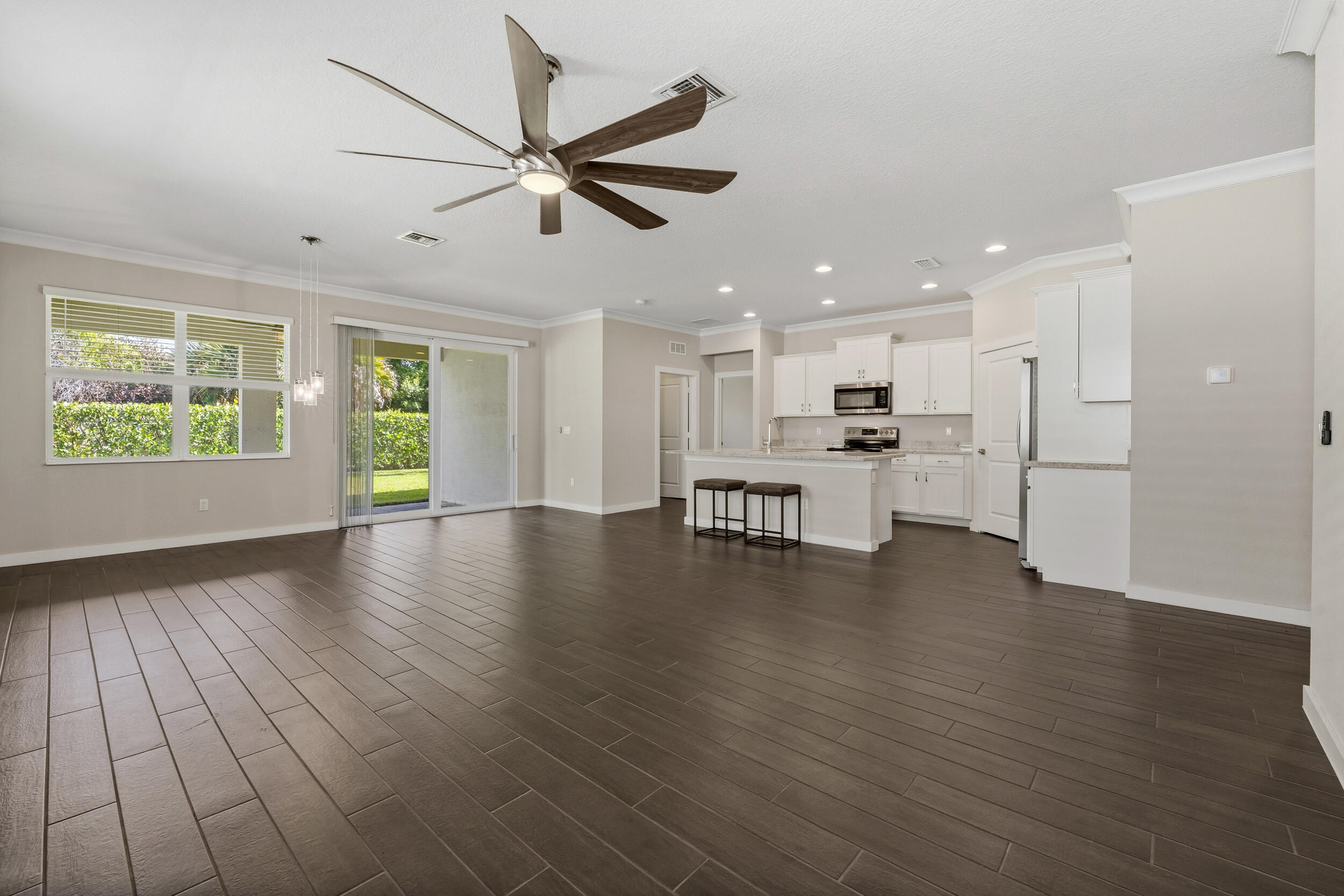 7461 Southwest Harbor Cove Drive Stuart, FL 34997 - Photo 10 of 30 a view of a kitchen with a fridge wooden floor and a window