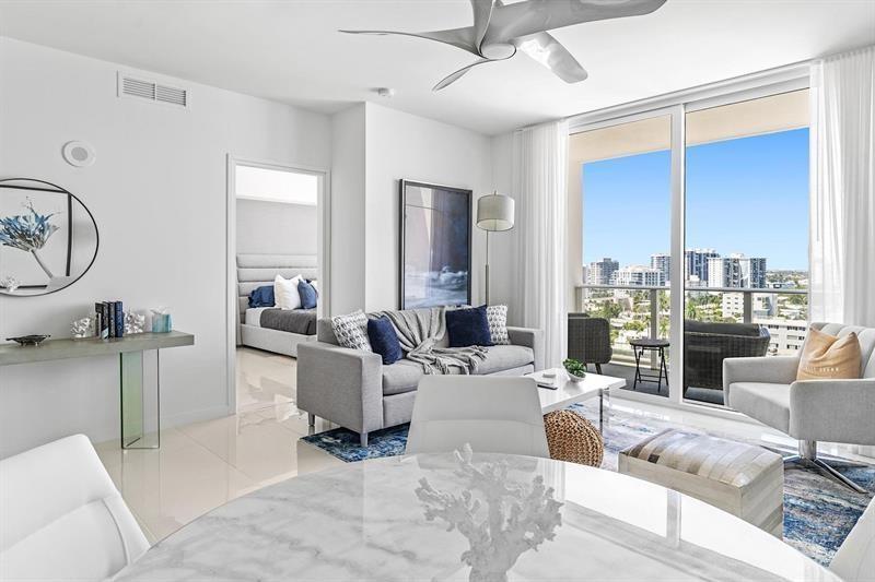 401 North Birch Road, Unit 1214 Fort Lauderdale, FL 33304 - Photo 14 of 47 a living room with furniture large window and flat screen tv