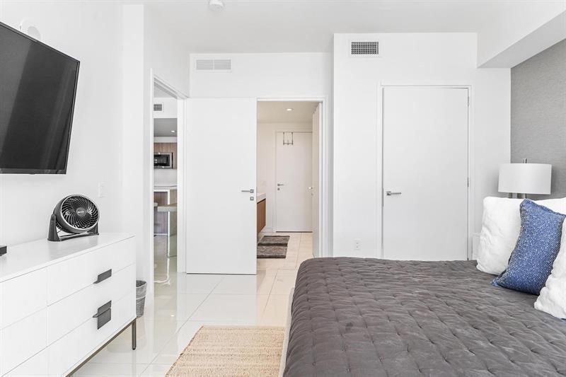 401 North Birch Road, Unit 1214 Fort Lauderdale, FL 33304 - Photo 21 of 47 a bedroom with a bed and a flat screen tv