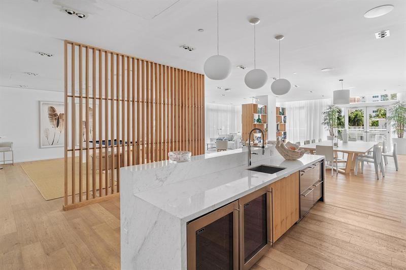 401 North Birch Road, Unit 1214 Fort Lauderdale, FL 33304 - Photo 32 of 47 a kitchen with stainless steel appliances granite countertop a sink a oven and a large window with wooden floor