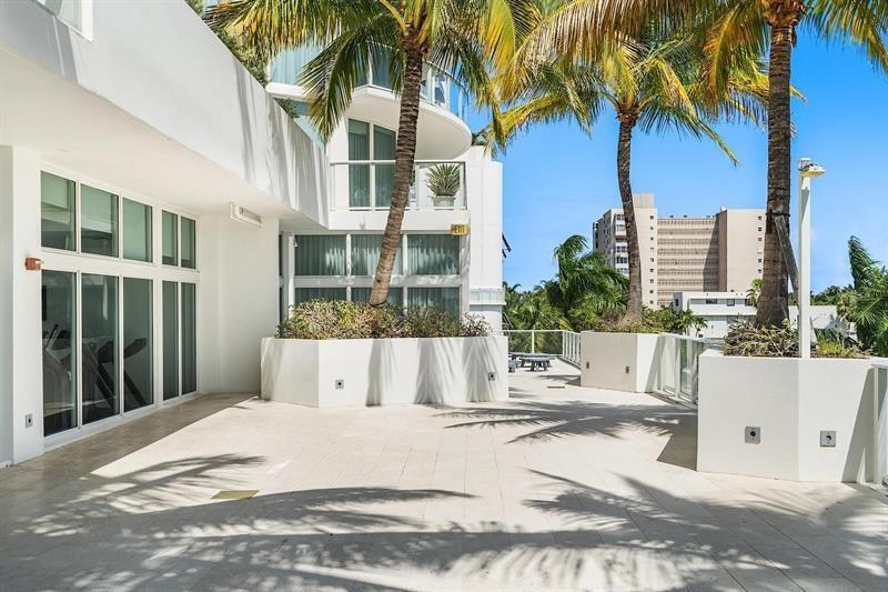 401 North Birch Road, Unit 1214 Fort Lauderdale, FL 33304 - Photo 39 of 47 a view of a building with a floor to ceiling window and potted plants
