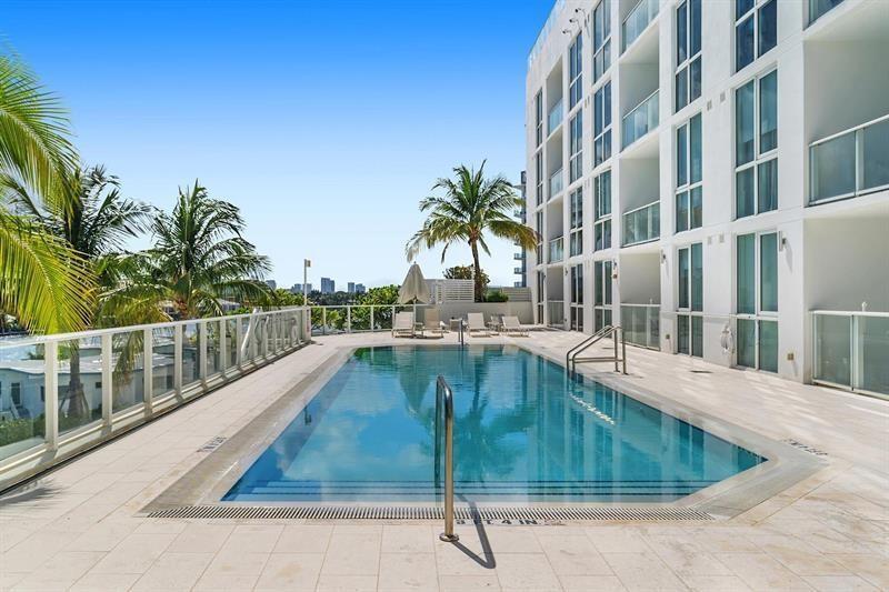 401 North Birch Road, Unit 1214 Fort Lauderdale, FL 33304 - Photo 42 of 47 a swimming pool with outdoor seating and yard