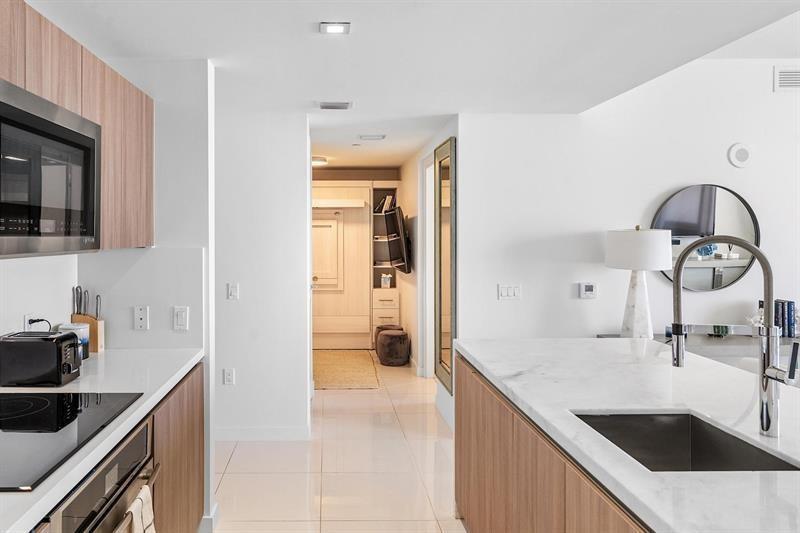 401 North Birch Road, Unit 1214 Fort Lauderdale, FL 33304 - Photo 10 of 47 a kitchen with a sink and a refrigerator