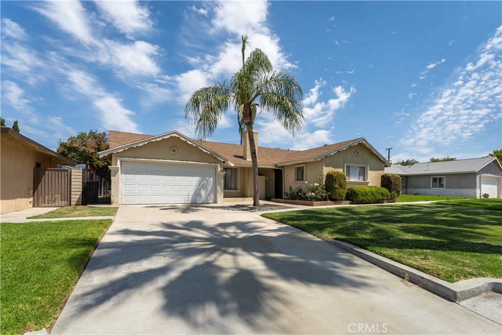 10401 Pendleton Street Riverside, CA 92505 - Photo 1 of 1 a front view of a house with a yard and garage