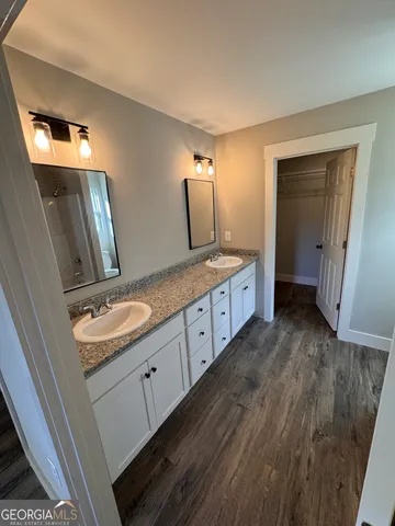 a bathroom with a double vanity sink and mirror