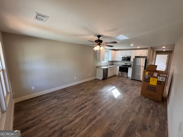 a view of kitchen and dining room with wooden floor