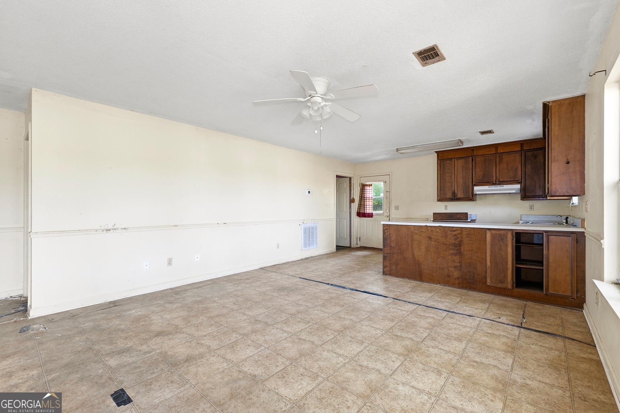 342 North Lake Drive Perry, GA 31069 - Photo 11 of 22 a view of kitchen with cabinets and wooden floor