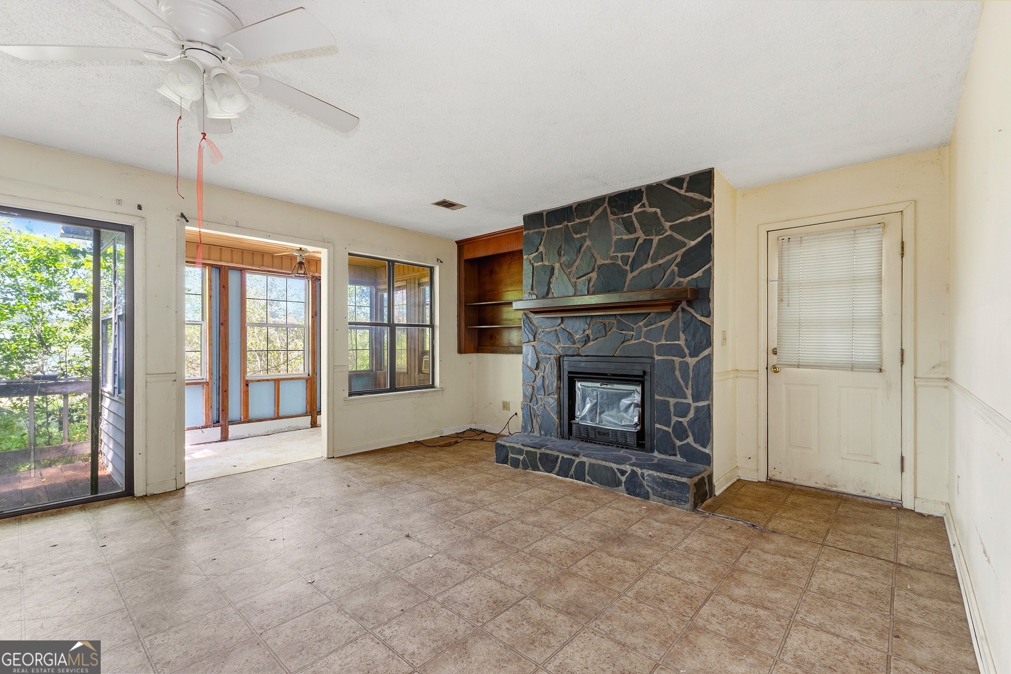 342 North Lake Drive Perry, GA 31069 - Photo 14 of 22 a view of an empty room with a fireplace and a window