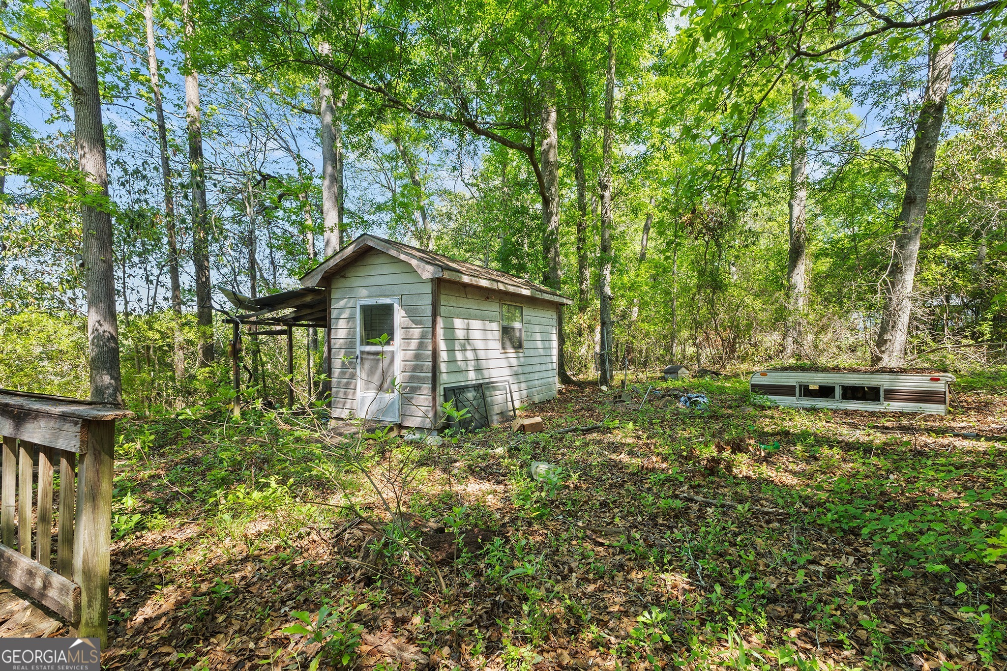 342 North Lake Drive Perry, GA 31069 - Photo 6 of 22 a yellow house with lots of trees in the background