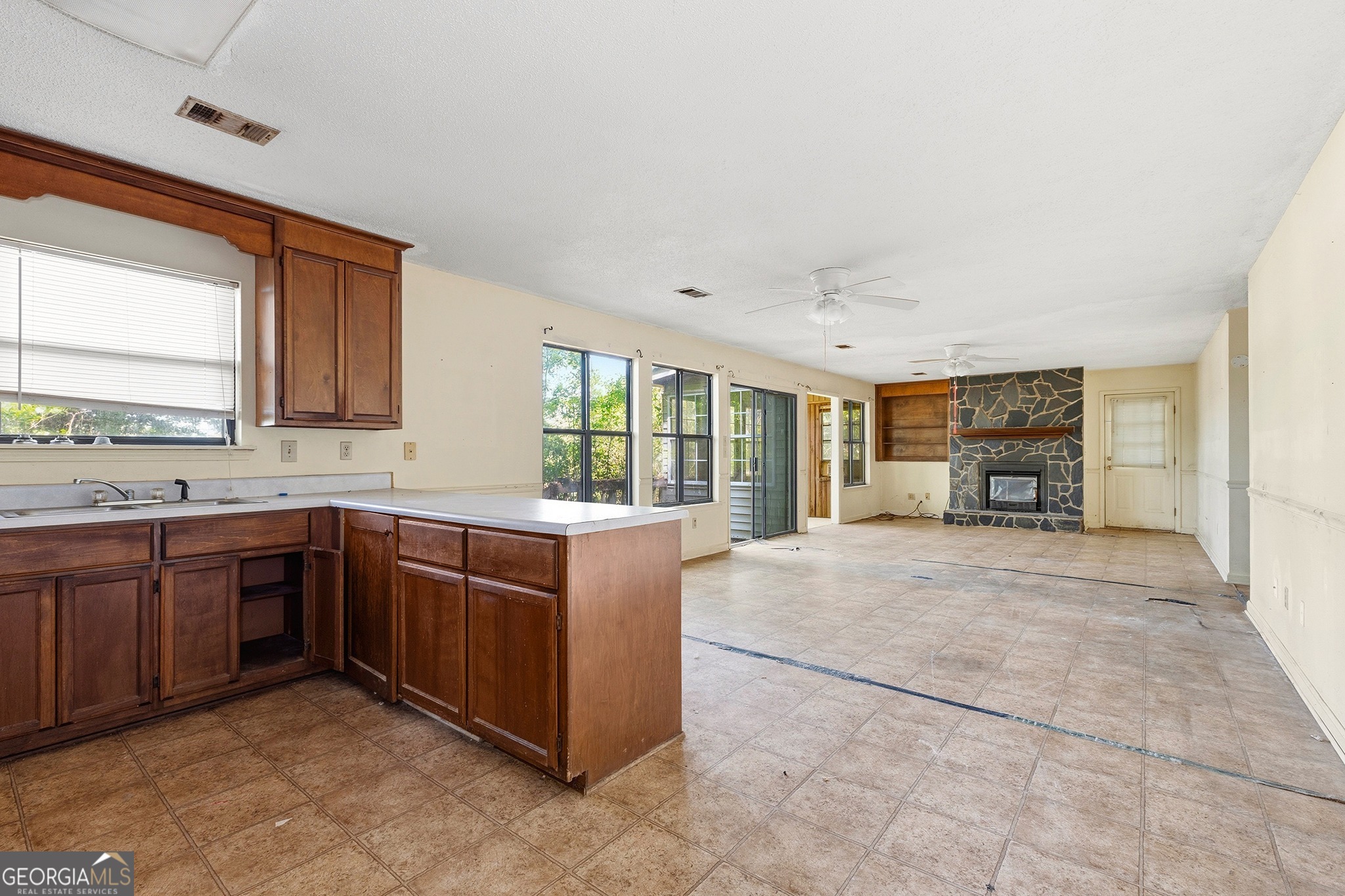 342 North Lake Drive Perry, GA 31069 - Photo 9 of 22 a large kitchen with cabinets and wooden floor