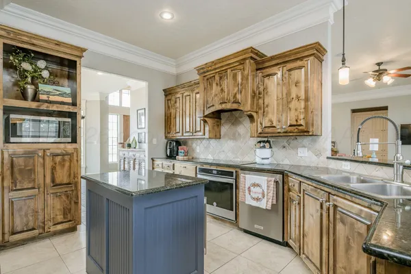 a kitchen with stainless steel appliances granite countertop a sink and refrigerator