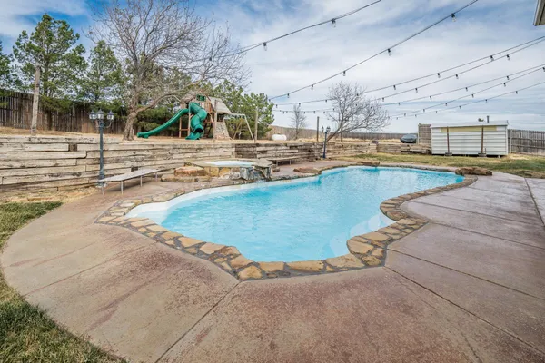 a view of a swimming pool with outdoor seating