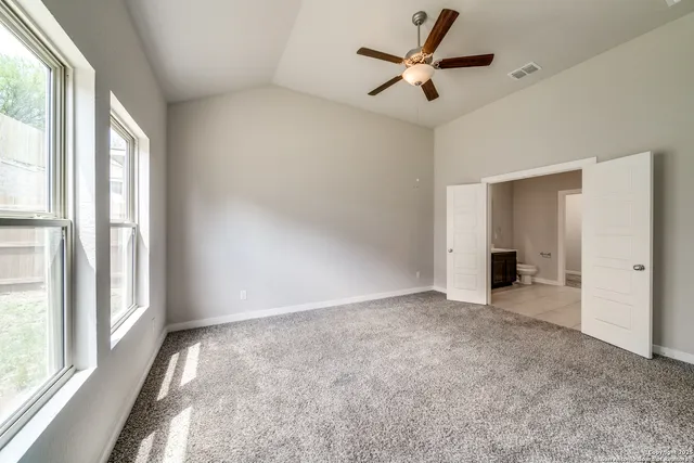 a spacious bathroom with a mirror a shower and a sink