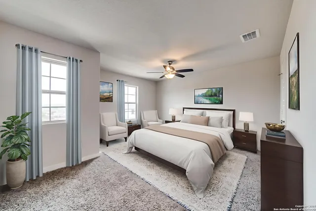 an empty room with windows and chandelier fan
