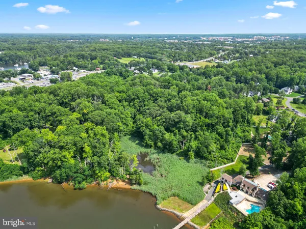 an aerial view of a houses with a lake view