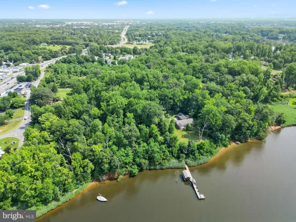 an aerial view of a house with a yard and lake view