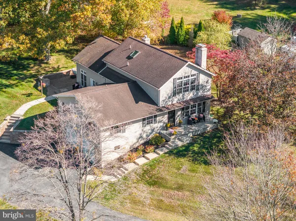 an aerial view of a house with a yard