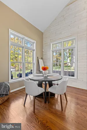 a reading room with furniture wooden floor and a window