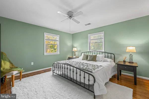 a bedroom with a bed and a lamp on table