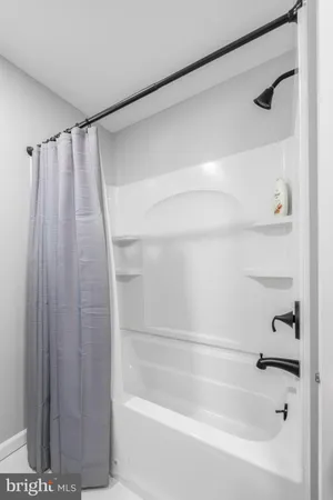 a bathroom with a shower and a bath tub