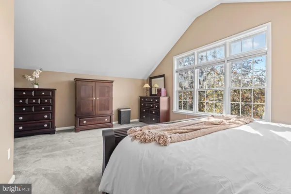 a bedroom with a large bed and a large window