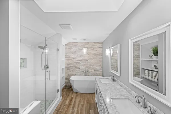 a spacious bathroom with a granite countertop tub sink and shower