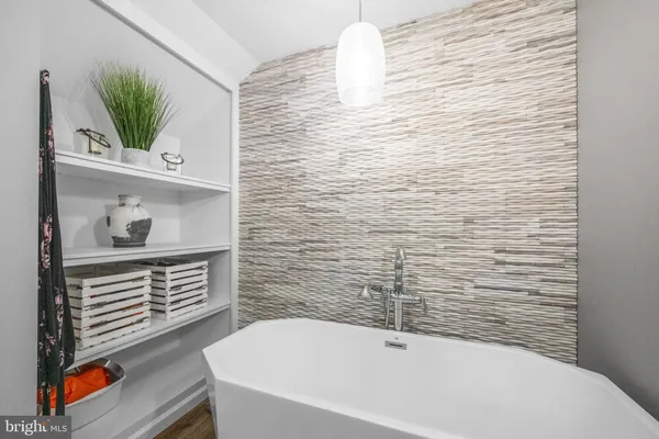a bathroom with a bathtub and a shower