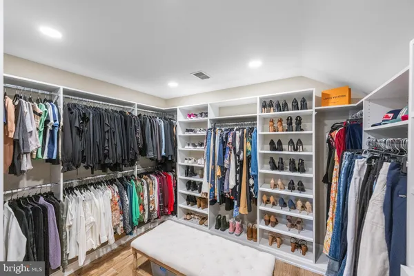 a view of walk in closet with clothes