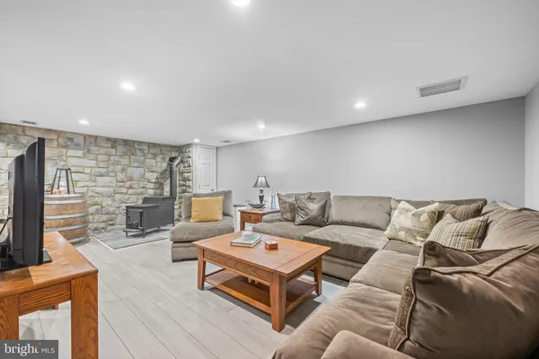 a living room with fireplace furniture and a flat screen tv
