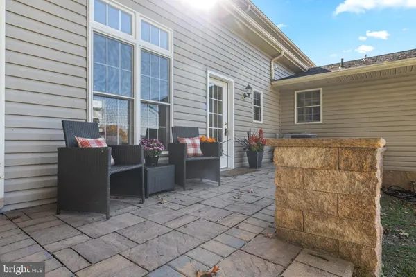 a view of a house with backyard and sitting area