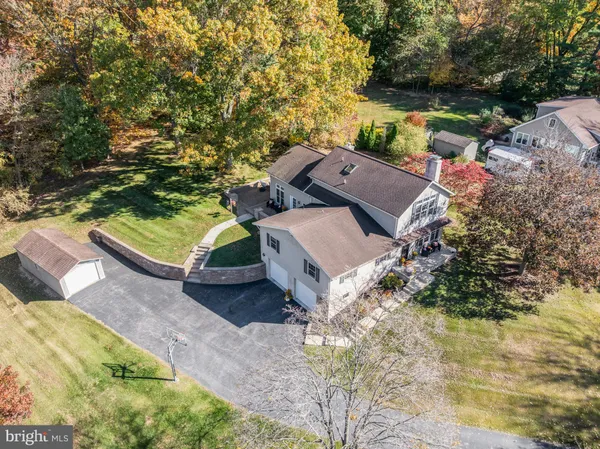 an aerial view of a house with a yard