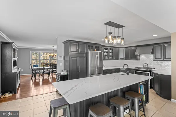 a view of a dining room with furniture a chandelier and wooden floor