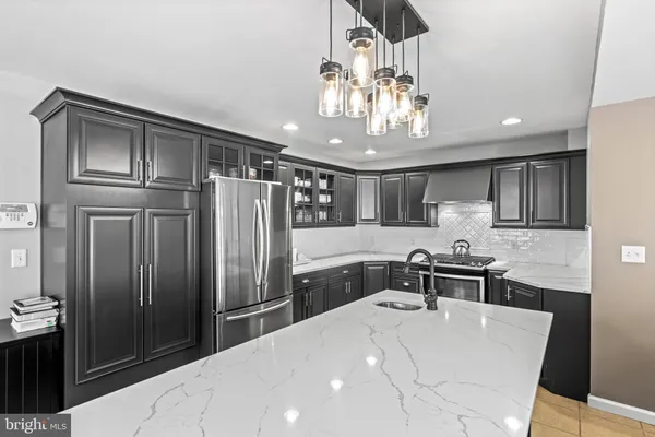 a kitchen with stainless steel appliances a refrigerator and a stove