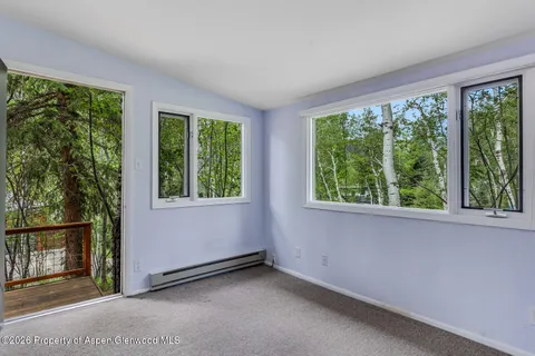 a view of an empty room with large windows