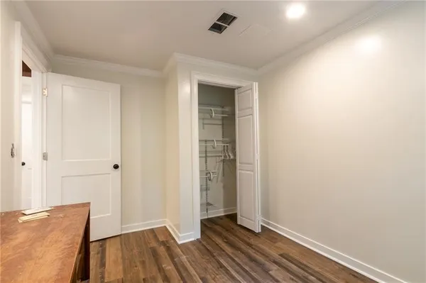 a view of room with window and wooden floor