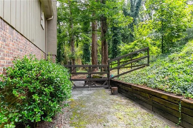 a backyard of a house with lots of green space and outdoor seating