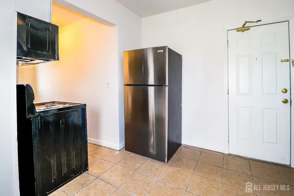 a metallic refrigerator freezer sitting in a kitchen