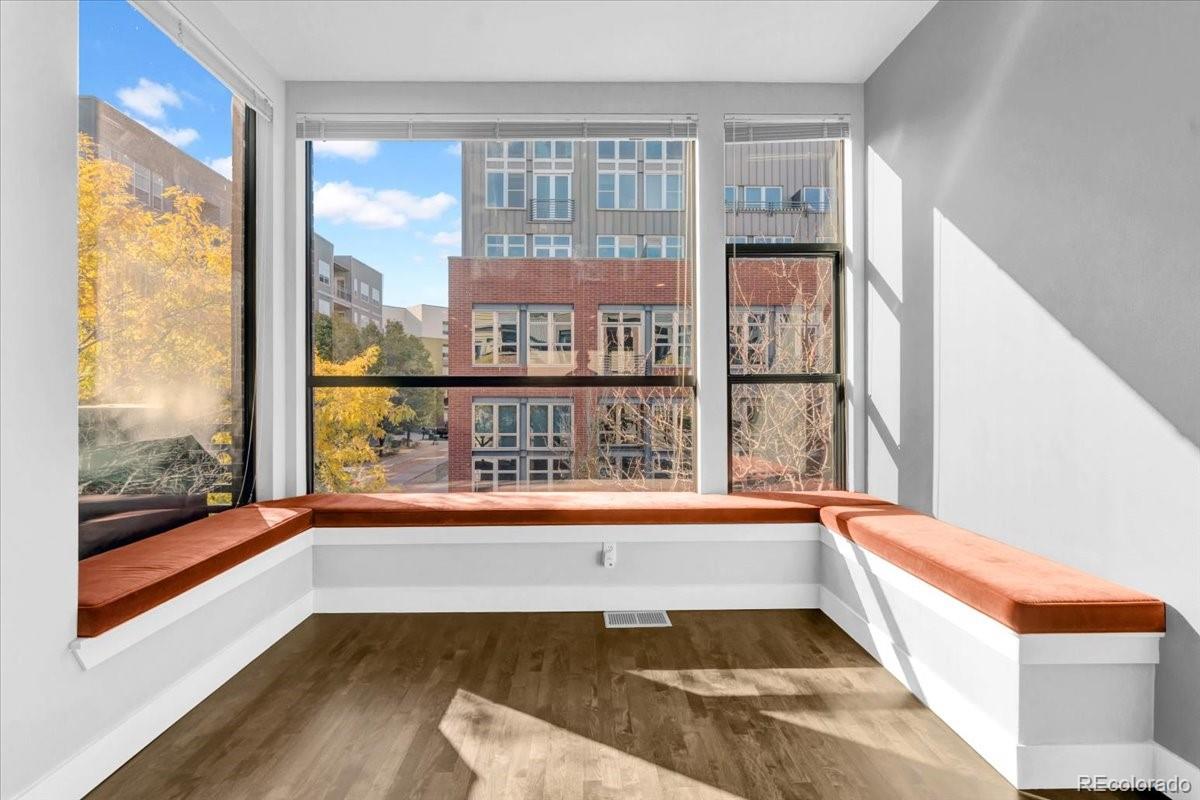 2900 Inca Street, Unit 15 Denver, CO 80202 - Photo 12 of 40 a view of an empty room with wooden floor and a window