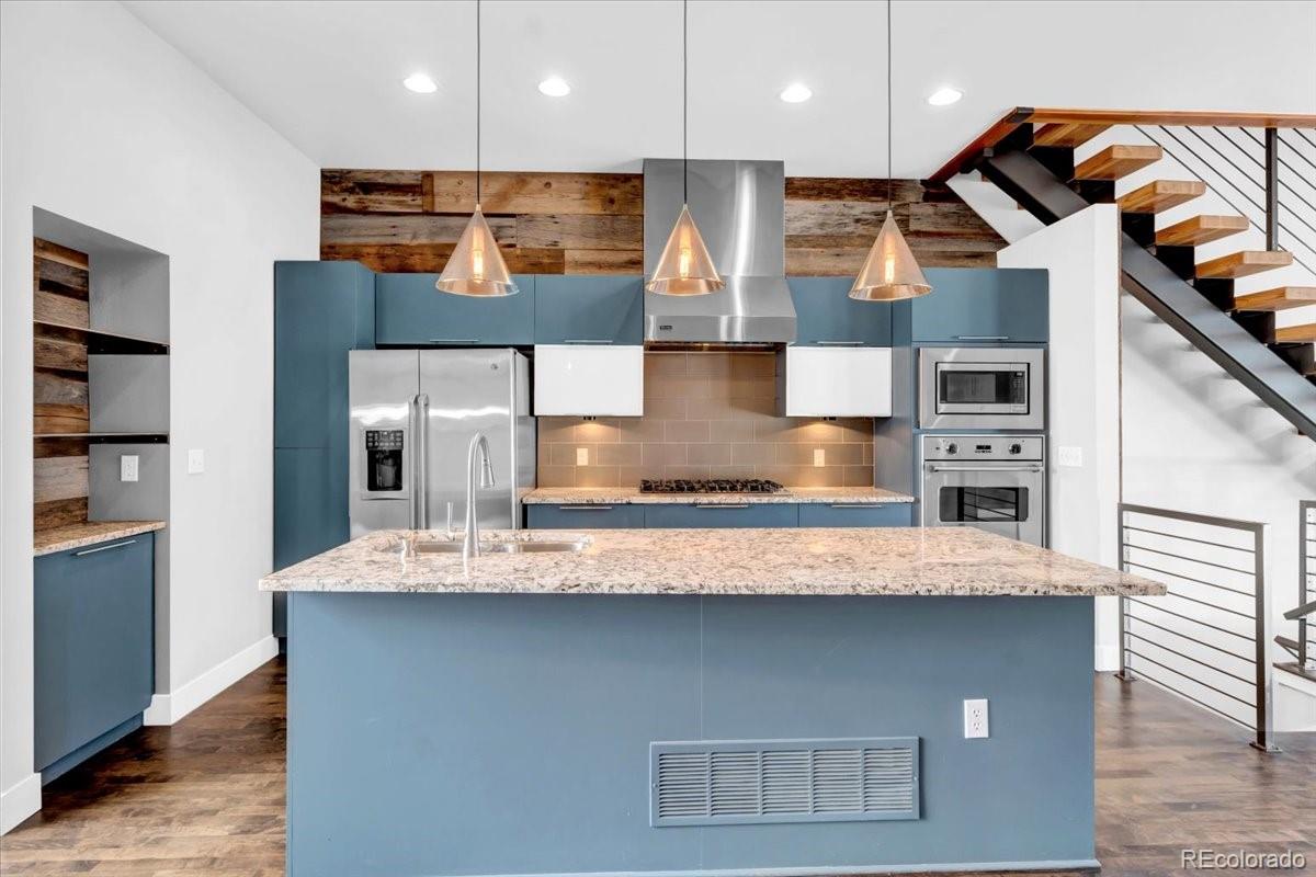 2900 Inca Street, Unit 15 Denver, CO 80202 - Photo 16 of 40 a large kitchen with stainless steel appliances kitchen island a large counter top