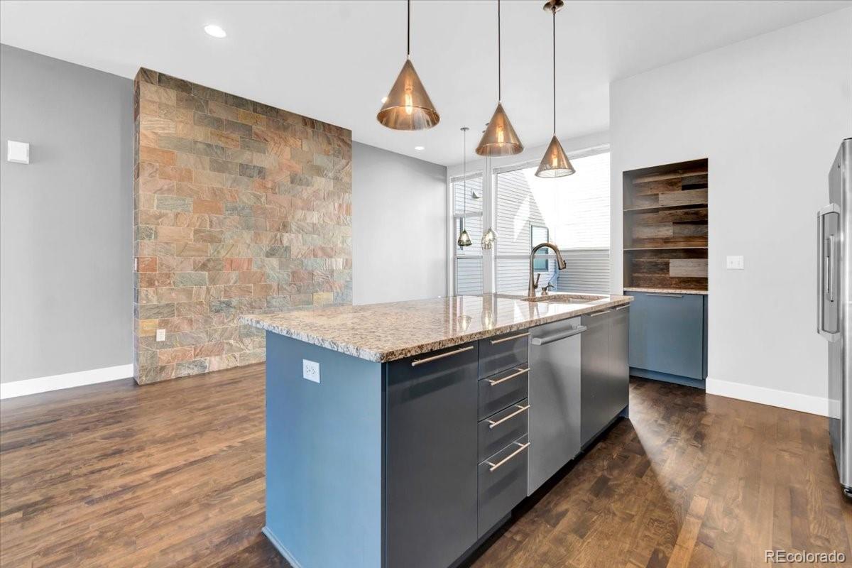 2900 Inca Street, Unit 15 Denver, CO 80202 - Photo 18 of 40 a kitchen with stainless steel appliances granite countertop a sink a stove and a wooden floors