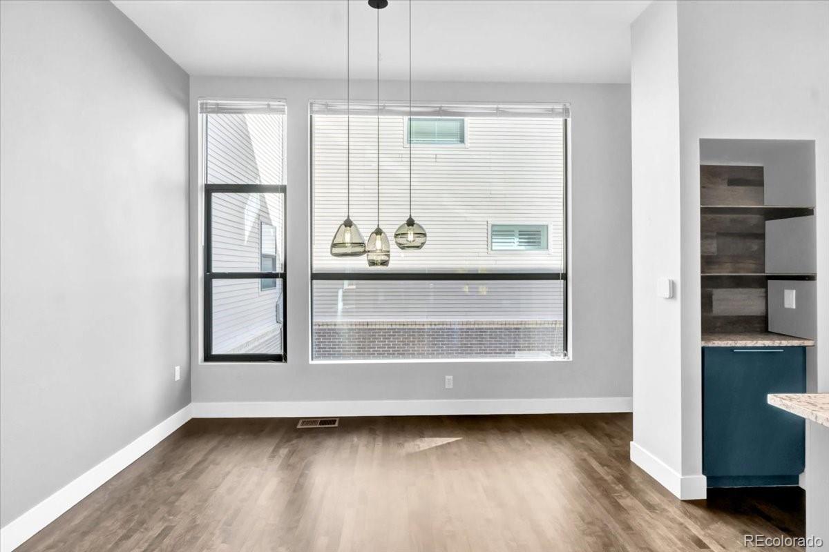 2900 Inca Street, Unit 15 Denver, CO 80202 - Photo 19 of 40 a view of an empty room with a window and wooden floor