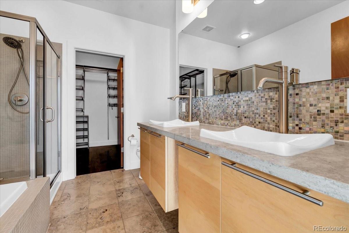 2900 Inca Street, Unit 15 Denver, CO 80202 - Photo 25 of 40 a kitchen with stainless steel appliances kitchen island granite countertop a refrigerator and a sink
